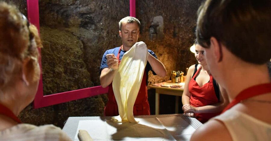 Salzburg: Dinner Cooking Class and Music - Rolling apple strudel dough by hand