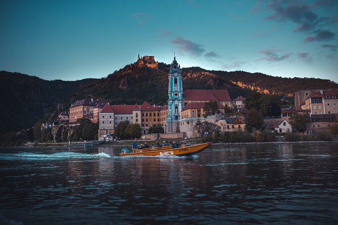 Wine tasting on traditional wooden boats in Wachau Valley - A Danube ride with a glass in hand