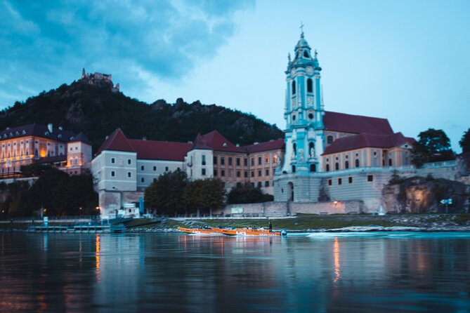 Wine tasting on traditional wooden boats in Wachau Valley - Dürnstein Castle, abbey, and ruined fortress